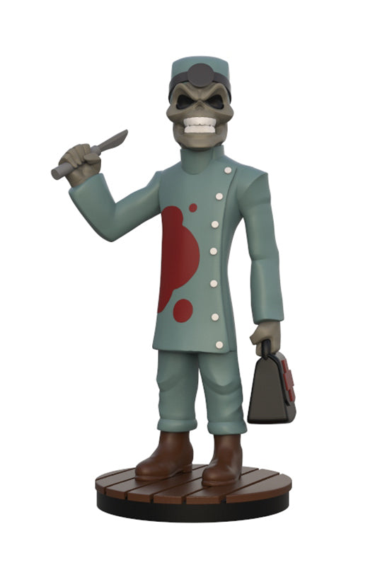 A stylized zombie doctor figurine standing on a round wooden base against a plain white background. The figure has a gray skull face, a teal-green coat with a red blood splatter, teal-green pants, brown boots, and holds a knife in one hand and a bag in the other.