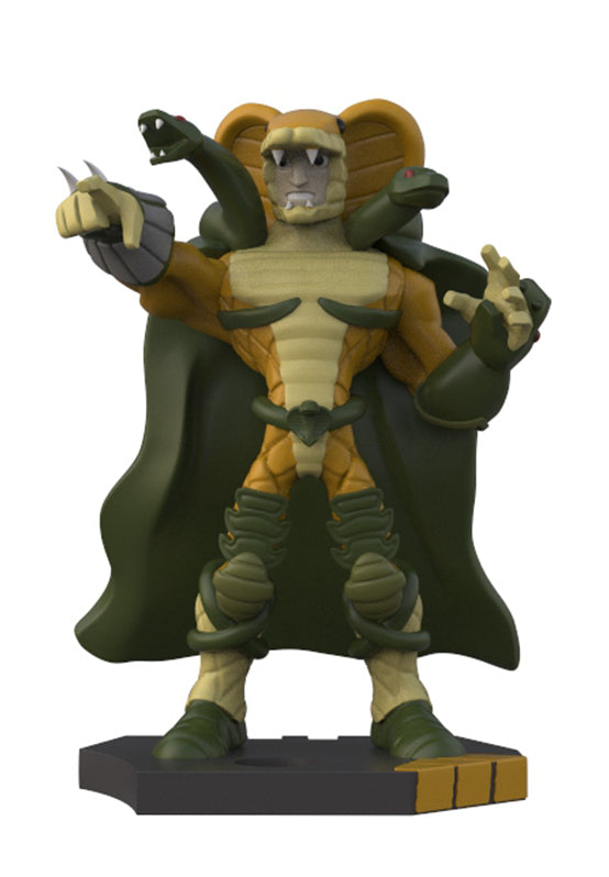 A collectible action figure of a reptilian alien character with a dark green cape, tan armor, and gray skin, standing on a dark gray base against a white background.