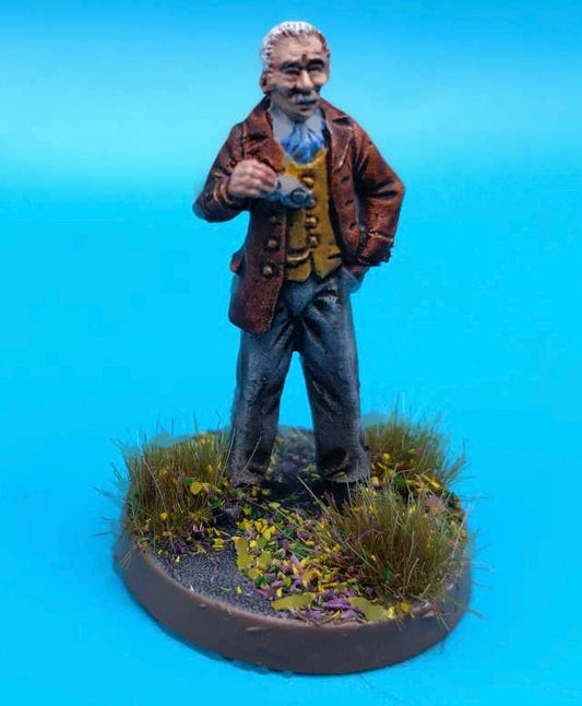 A painted tabletop miniature figurine of an elderly man (Professor) standing on a round grassy base against a bright blue background.