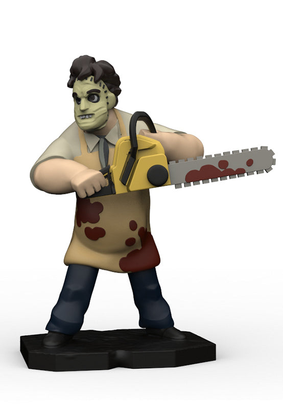 A stylized horror character figurine holding a yellow chainsaw with red splatter details, standing on a black base against a plain white background.