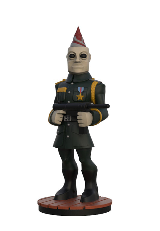 A stylized collectible figurine of a soldier character wearing a dark green military uniform, black boots, and a red-and-white striped party hat, holding a black weapon, standing on a round brown base against a plain white background.