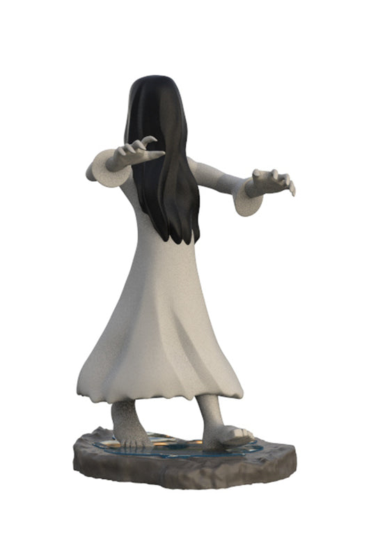 A miniature figurine of a ghostly woman with long black hair and a flowing white dress, standing on a rocky base against a plain white background.